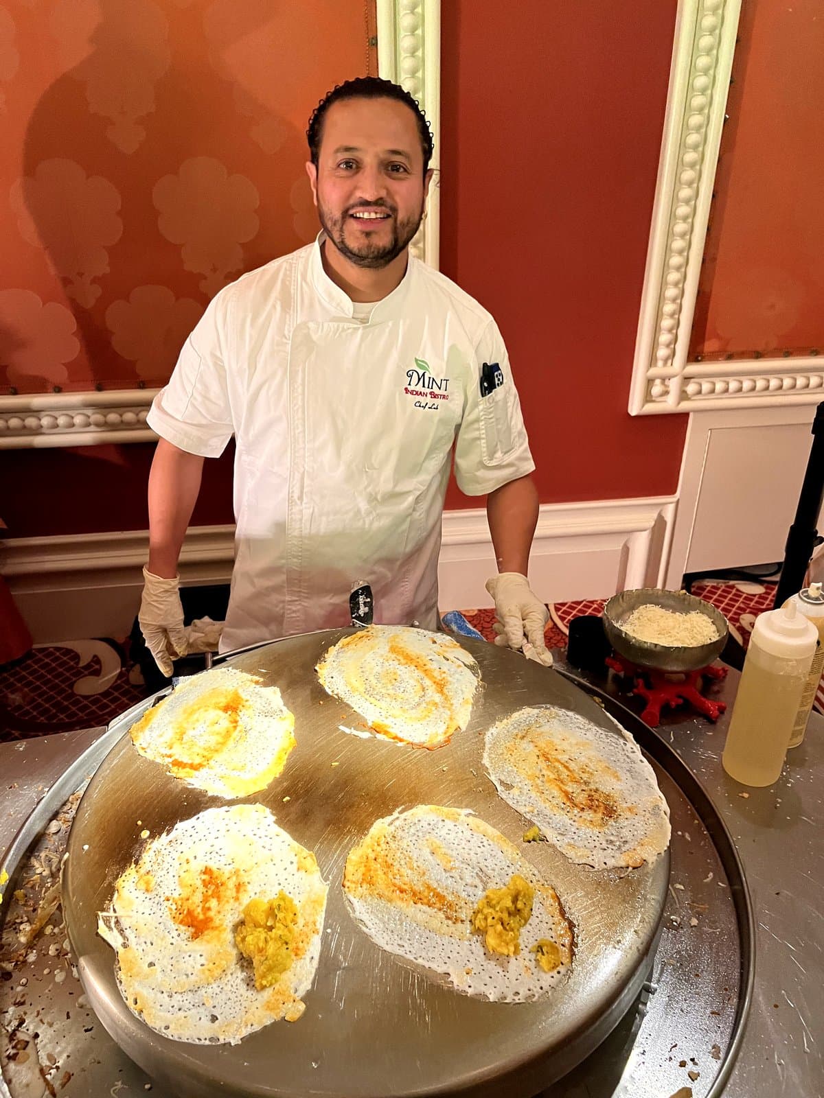 Mint chef cooking dosas at a live catering station